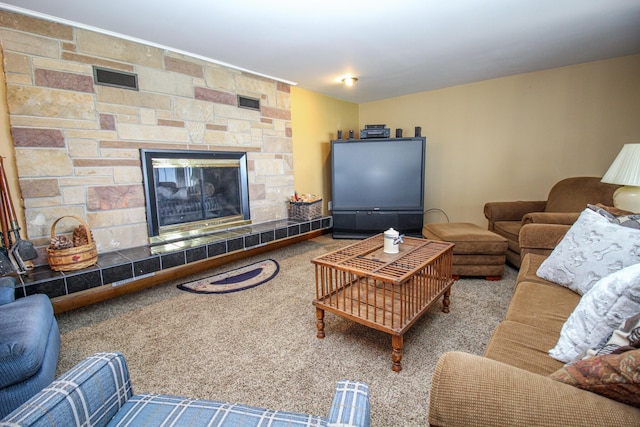 living room featuring carpet floors, visible vents, and a fireplace