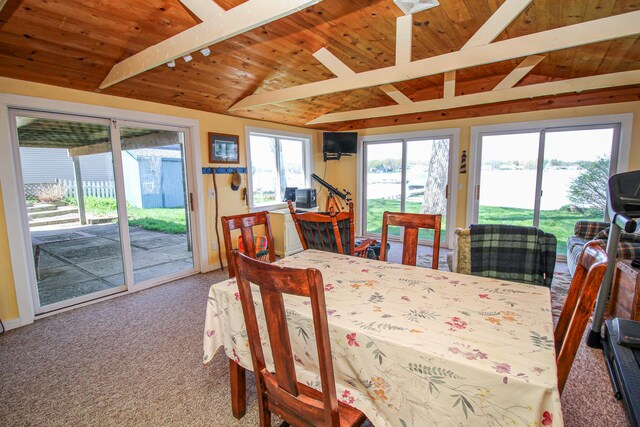 dining area featuring wooden ceiling, vaulted ceiling with beams, and carpet