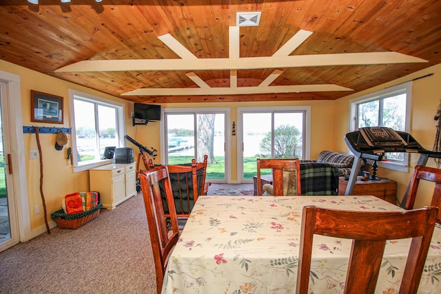 carpeted dining area featuring baseboards, visible vents, lofted ceiling with beams, and wood ceiling