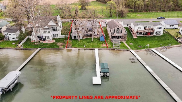 drone / aerial view with a water view and a residential view