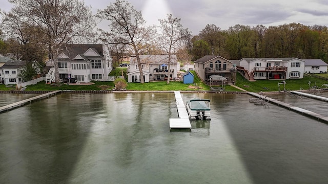 property view of water with a residential view, a boat dock, and stairway
