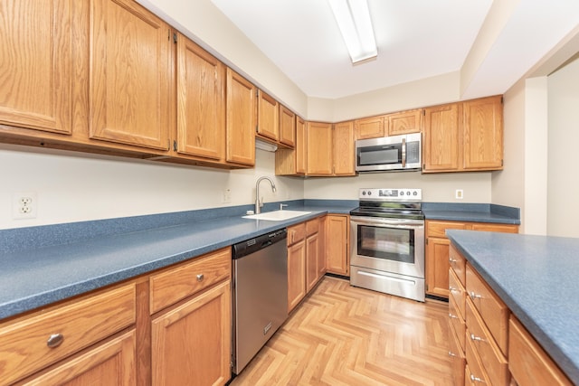 kitchen with a sink, dark countertops, and stainless steel appliances