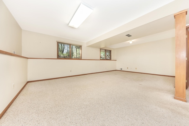unfurnished room featuring carpet flooring, baseboards, and visible vents