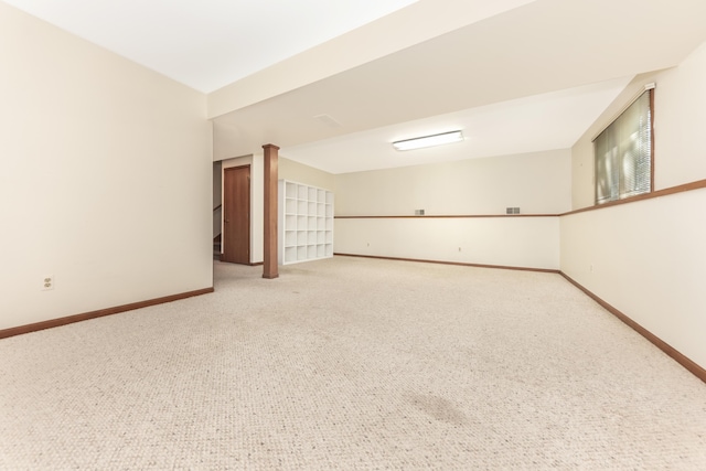 spare room with baseboards and carpet