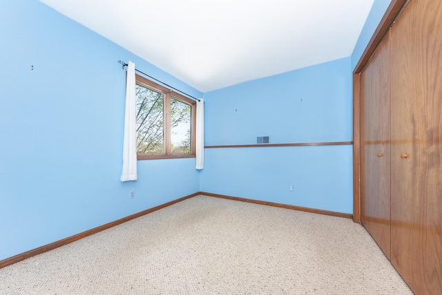 unfurnished room featuring baseboards, carpet, and visible vents