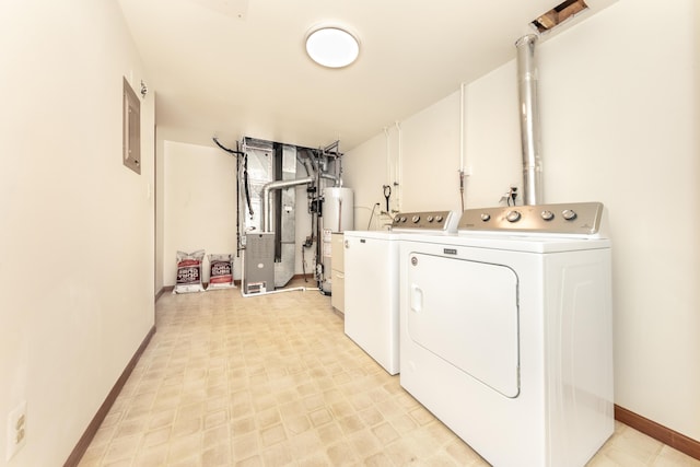 laundry room featuring heating unit, baseboards, electric panel, separate washer and dryer, and water heater