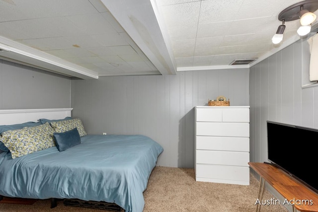 carpeted bedroom featuring visible vents