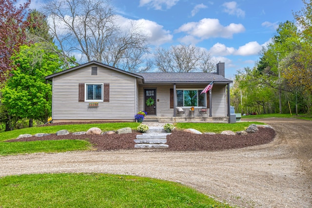 1205 Mckail Rd, Leonard, MI 48367 - ranch-style home featuring dirt driveway, a chimney, a porch, and a front lawn
