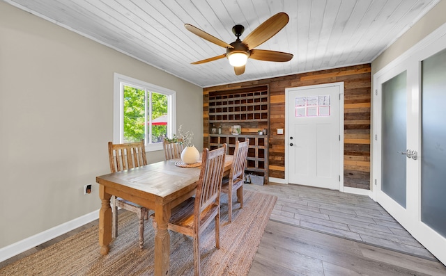 1205 Mckail Rd, Leonard, MI 48367 - dining area featuring wooden ceiling, wooden walls, a ceiling fan, hardwood / wood-style flooring, and baseboards