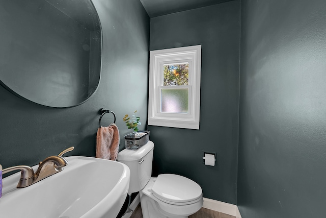 1205 Mckail Rd, Leonard, MI 48367 - bathroom featuring a sink, toilet, and baseboards