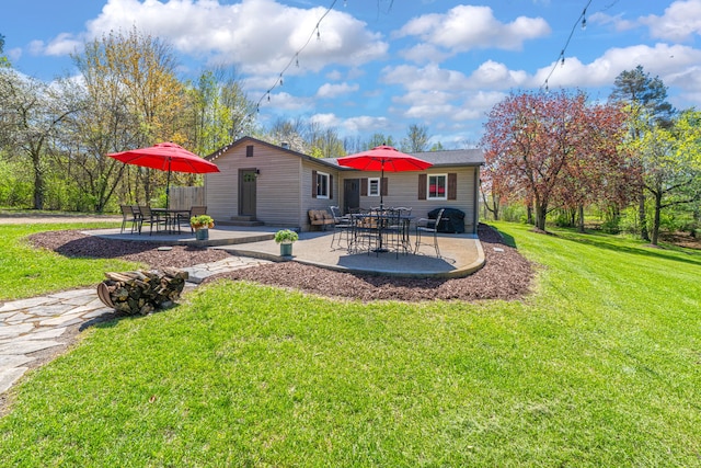 1205 Mckail Rd, Leonard, MI 48367 - rear view of house with a patio area and a yard