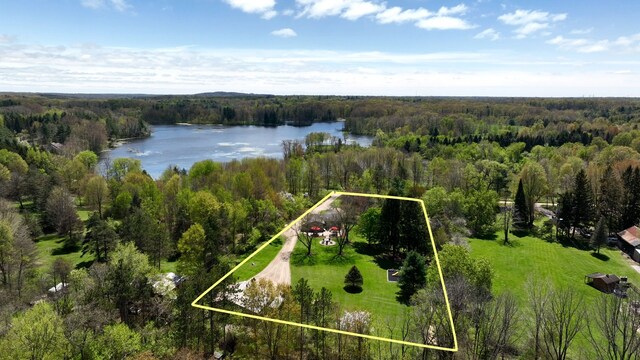 1205 Mckail Rd, Leonard, MI 48367 - aerial overview of property's location featuring a heavily wooded area, a nearby body of water, and property boundaries highlighted