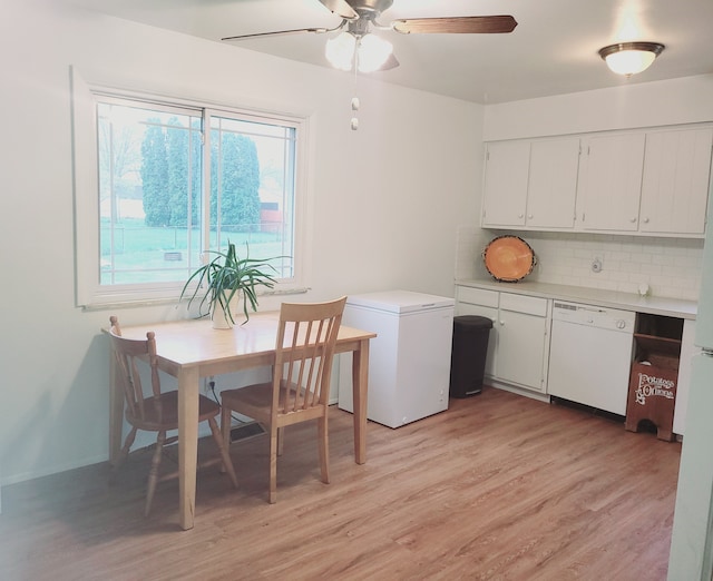 dining space with light wood-style floors and ceiling fan