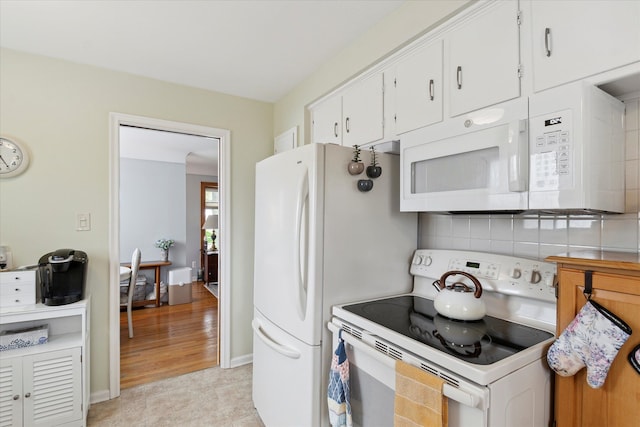kitchen with light tile patterned floors, baseboards, white appliances, white cabinetry, and decorative backsplash