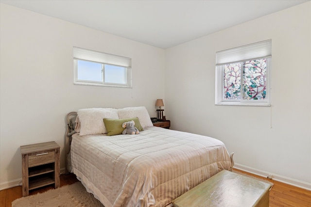 bedroom with wood finished floors and baseboards