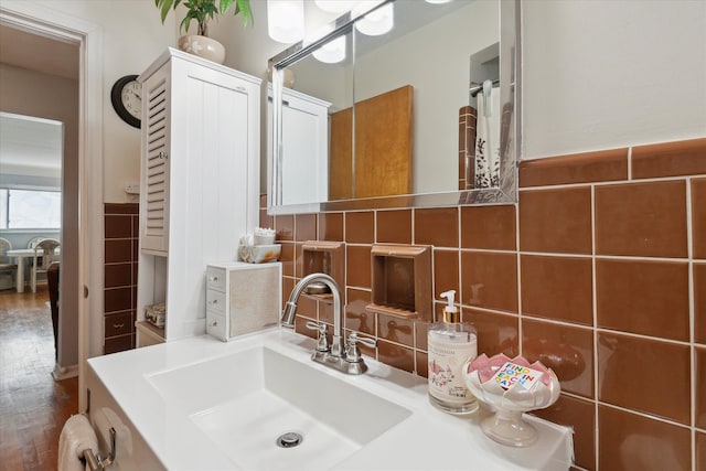 bathroom with vanity, tile walls, decorative backsplash, and wood finished floors