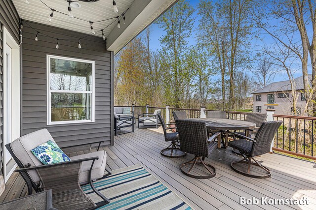 3779 Mesa Verde Dr, Hudsonville, MI 49426 - wooden deck with a ceiling fan and outdoor dining space