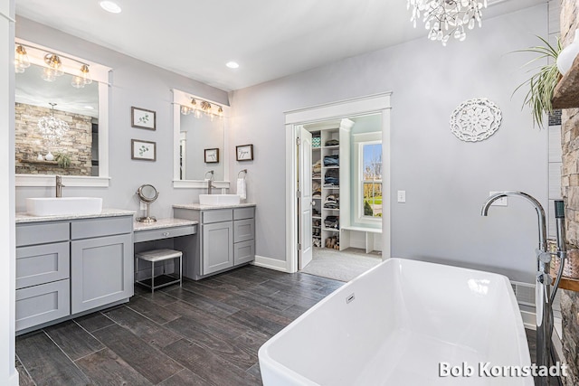 3779 Mesa Verde Dr, Hudsonville, MI 49426 - full bathroom featuring a sink, wood finished floors, and a notable chandelier