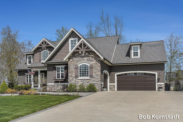 3779 Mesa Verde Dr, Hudsonville, MI 49426 - craftsman inspired home with a front lawn, stone siding, roof with shingles, concrete driveway, and an attached garage