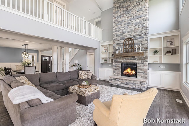 3779 Mesa Verde Dr, Hudsonville, MI 49426 - living area with plenty of natural light, a high ceiling, dark wood-style floors, and a fireplace