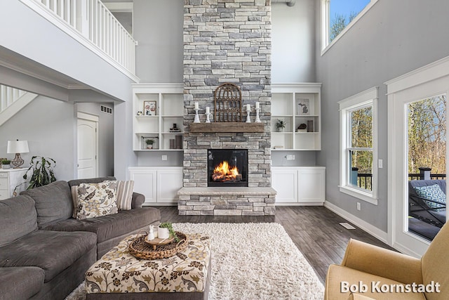 3779 Mesa Verde Dr, Hudsonville, MI 49426 - living room featuring visible vents, dark wood-style floors, a stone fireplace, and a towering ceiling