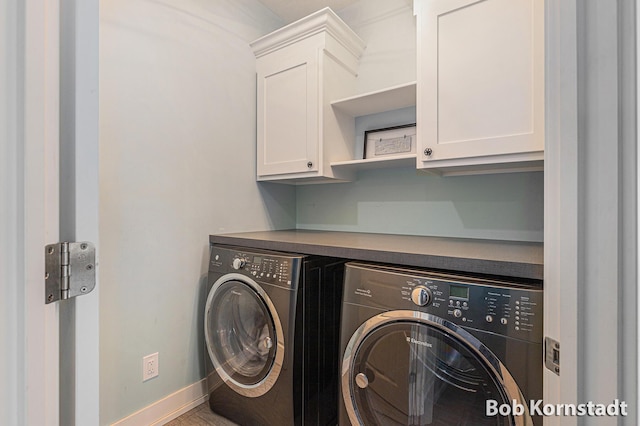 3779 Mesa Verde Dr, Hudsonville, MI 49426 - clothes washing area with baseboards, washing machine and dryer, and cabinet space