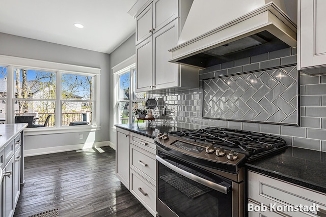 3779 Mesa Verde Dr, Hudsonville, MI 49426 - kitchen with tasteful backsplash, dark wood finished floors, gas stove, premium range hood, and baseboards