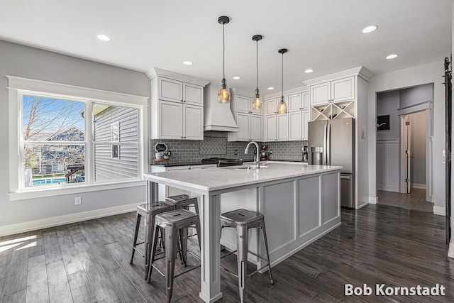 3779 Mesa Verde Dr, Hudsonville, MI 49426 - kitchen with decorative backsplash, baseboards, stainless steel fridge, a sink, and dark wood finished floors