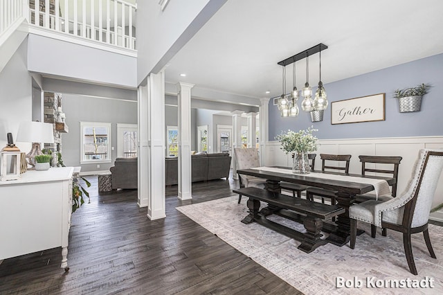 3779 Mesa Verde Dr, Hudsonville, MI 49426 - dining room featuring dark wood-style flooring, a decorative wall, a wainscoted wall, recessed lighting, and ornate columns