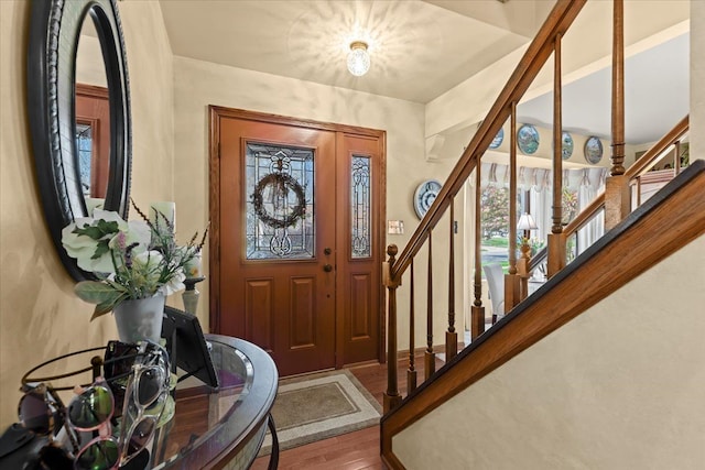 foyer featuring wood finished floors and stairway