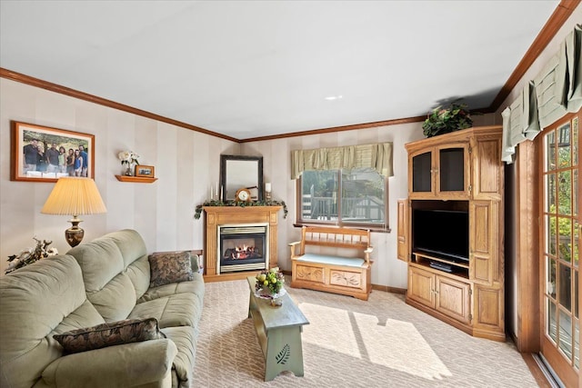living area featuring light colored carpet, baseboards, a glass covered fireplace, and ornamental molding