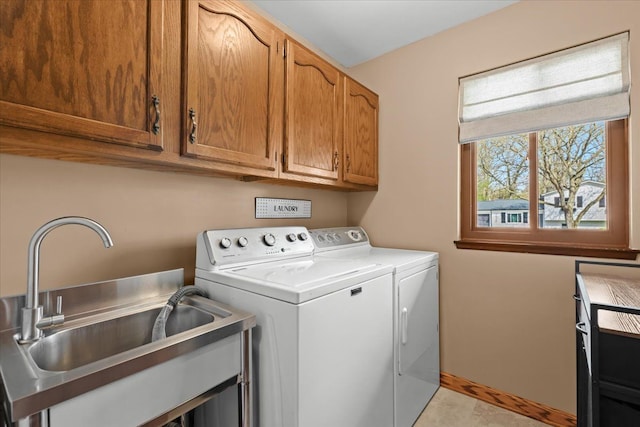 washroom with separate washer and dryer, a sink, and cabinet space