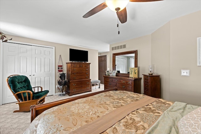 bedroom with visible vents, carpet flooring, a ceiling fan, and a closet