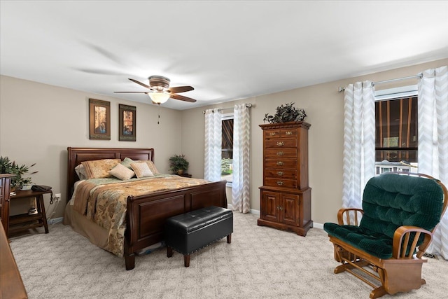 bedroom with baseboards, a ceiling fan, and light colored carpet
