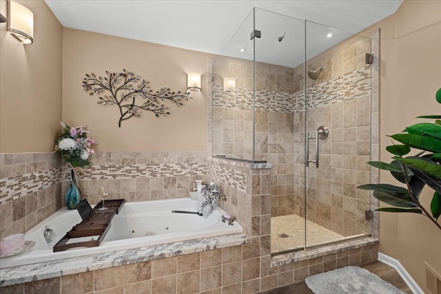 full bathroom featuring recessed lighting, a stall shower, and a tub with jets