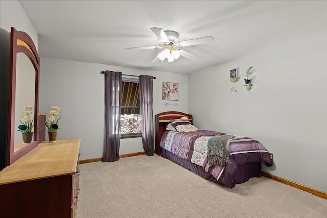 bedroom featuring baseboards, a ceiling fan, and light colored carpet