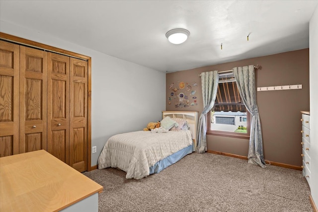 bedroom with baseboards and light carpet