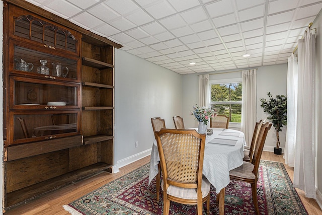 dining room with baseboards and light wood-type flooring