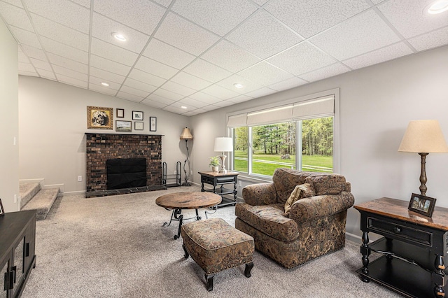 living room with recessed lighting, carpet, and a brick fireplace