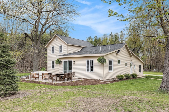 back of house featuring a patio, a shingled roof, outdoor lounge area, and a lawn