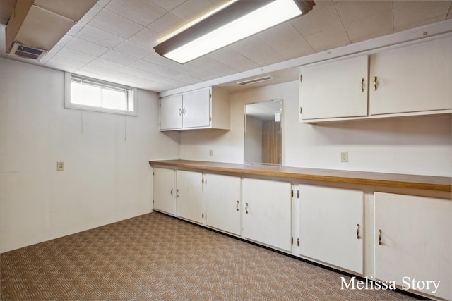 kitchen with visible vents, light countertops, and white cabinetry