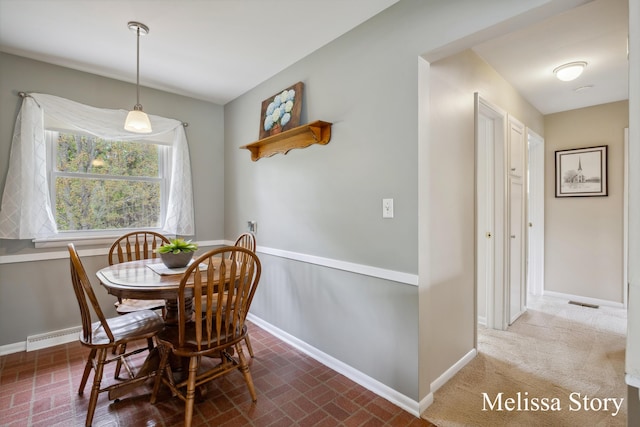 dining area with baseboards, brick patterned floor, and visible vents
