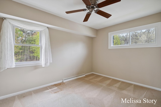 empty room with carpet floors, a ceiling fan, baseboards, and baseboard heating