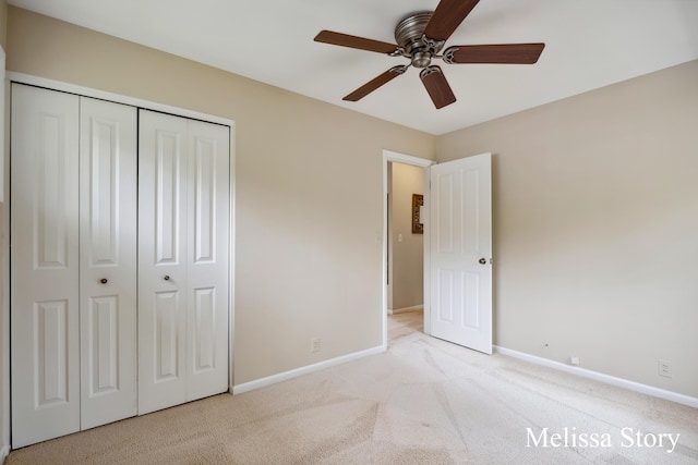 unfurnished bedroom featuring baseboards, ceiling fan, carpet, and a closet