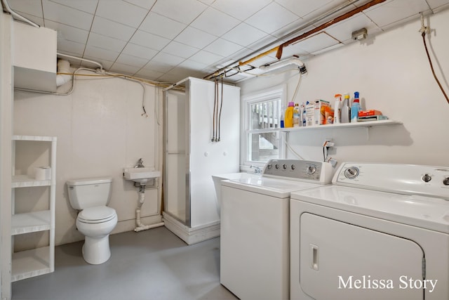 clothes washing area featuring washing machine and clothes dryer and laundry area