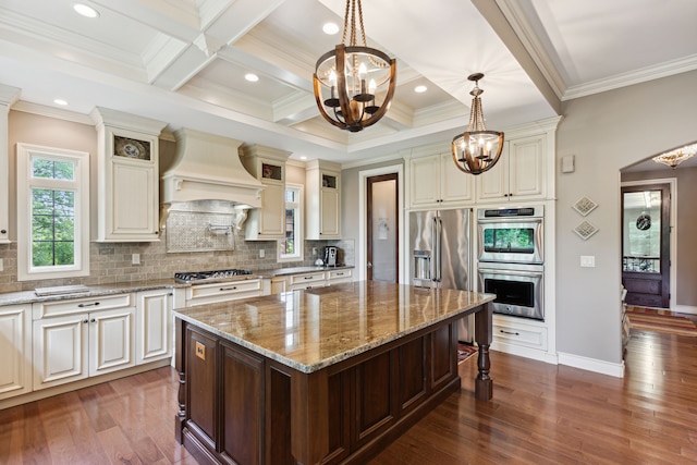11599 Erins Way, Romeo, MI 48065 - kitchen with a chandelier, appliances with stainless steel finishes, premium range hood, crown molding, and a kitchen breakfast bar