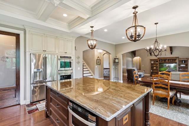 11599 Erins Way, Romeo, MI 48065 - kitchen featuring stainless steel appliances, arched walkways, cream cabinets, a chandelier, and light stone counters