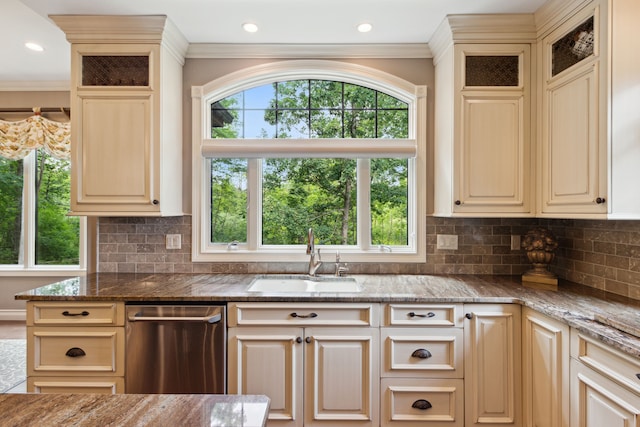 11599 Erins Way, Romeo, MI 48065 - kitchen with stainless steel dishwasher, a sink, cream cabinetry, ornamental molding, and dark stone countertops