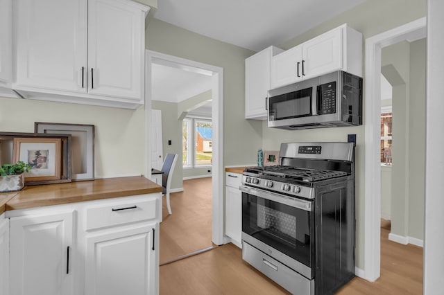 19950 Gilchrist St, Detroit, MI 48235 - kitchen featuring light wood-style floors, white cabinetry, and appliances with stainless steel finishes