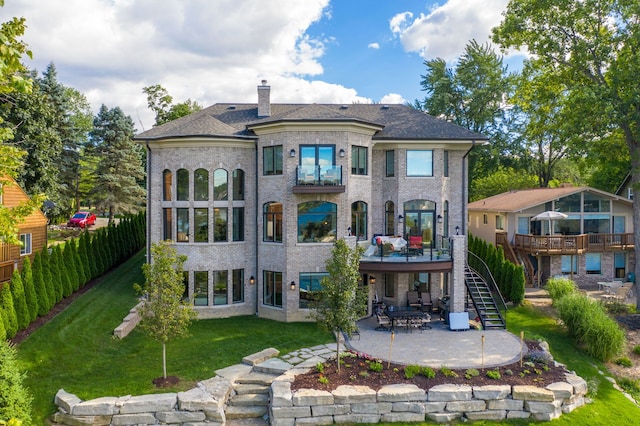5820 Lakeview Ave, Orchard Lake, MI 48323 - rear view of house featuring a chimney, a patio area, stairway, a balcony, and a yard